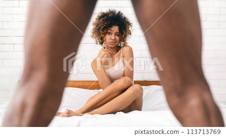 Woman in disbelief looking what's between man's legs 113713769