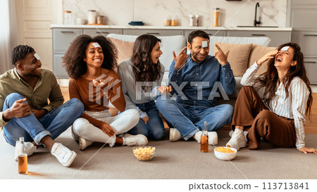 Laughing friends having a casual conversation at home Laughing friends having a casual conversation at home 113713841