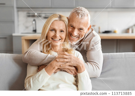 Mature couple smiling and hugging tightly 113713885