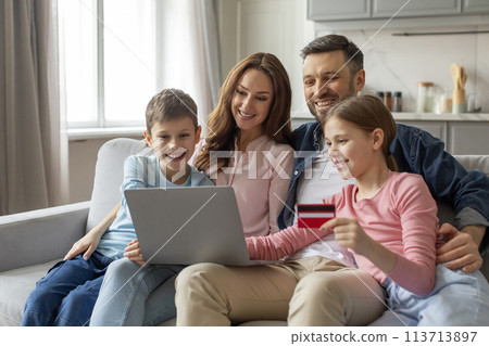 Family shopping online with credit card at home Family shopping online with credit card at home 113713897
