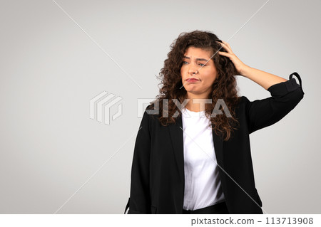 Woman with hand on head in confusion Woman with hand on head in confusion 113713908