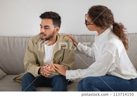Man receiving consolation from a woman therapist 113714150