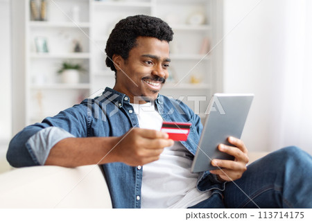 Smiling Black Man Shopping Online With Credit Card And Tablet 113714175