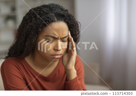 Black Woman Experiencing Headache at Home 113714303