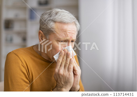 Senior man holding a blank square in front of face Senior man holding a blank square in front of face 113714431