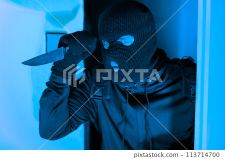 Masked thief peeking around door, break in 113714700