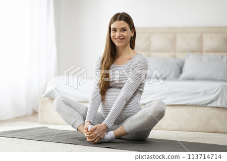 Young woman practicing yoga indoors at home 113714714