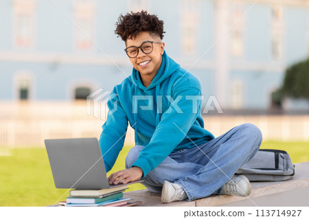 Happy student using laptop on university campus Happy student using laptop on university campus 113714927