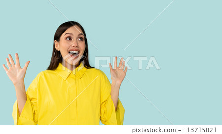 Surprised excited happy young hispanic woman in yellow shirt gesturing raising hands up, Surprised excited happy young hispanic woman in yellow shirt gesturing raising hands up, 113715021