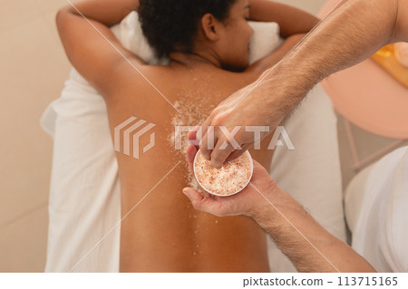 African American woman receiving a back scrub treatment 113715165