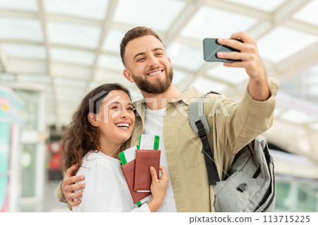Man and Woman Taking Selfie On Smartphone in Airport 113715225