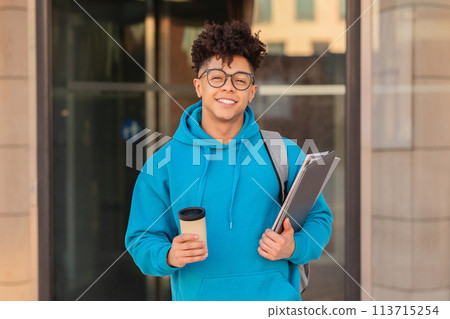 Smiling student with binder and coffee Smiling student with binder and coffee 113715254