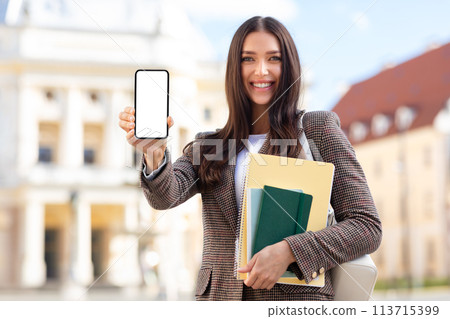 Happy student holding up smartphone with screen 113715399