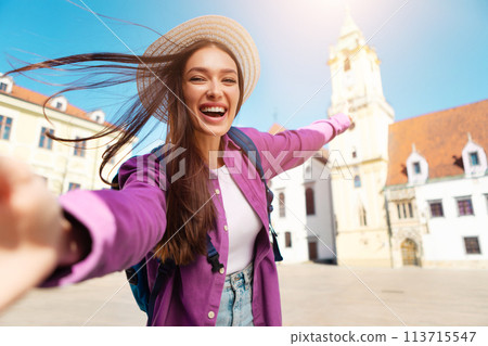 Happy tourist taking a selfie in European city 113715547