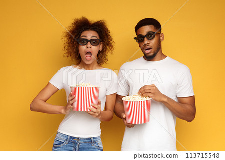 Shocked couple 3d glasses watching movie with popcorn 113715548