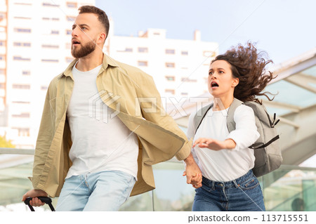 Man looking shocked holding woman's hand 113715551