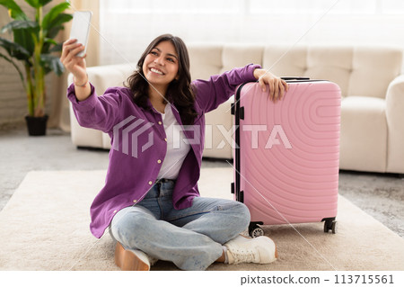 Traveler taking a selfie with suitcase at home 113715561