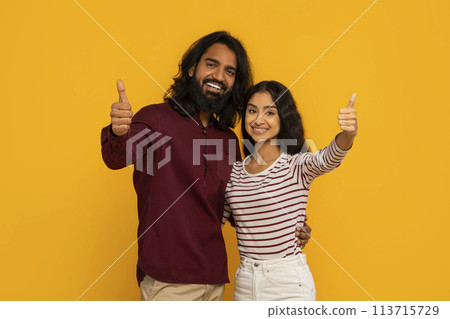 Couple gives thumbs up as woman smiles brightly Couple gives thumbs up as woman smiles brightly 113715729