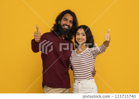 Couple gives thumbs up as woman smiles brightly Couple gives thumbs up as woman smiles brightly 113715740