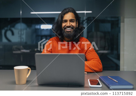 Smiling bearded man with laptop Smiling bearded man with laptop 113715892