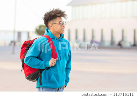 Student walking with backpack and looking away Student walking with backpack and looking away 113716111