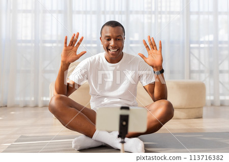 Man doing online yoga class from home 113716382