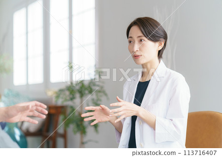 Photo of a female doctor examining a patient Photo of a female doctor examining a patient 113716407