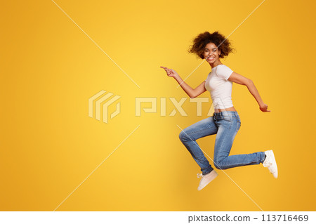 Funny portrait on young african american woman in humorous jump 113716469