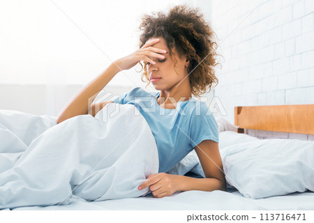 Woman touching forehead, having headache in the morning Woman touching forehead, having headache in the morning 113716471