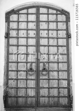 Wooden door to the church, Kyiv, Ukraine. St.Cyril church exterior, monochrome. Ancient doorway to cathedral. Ukrainian historical church. Vintage wooden entrance to the dome. Religious architecture.  113716565