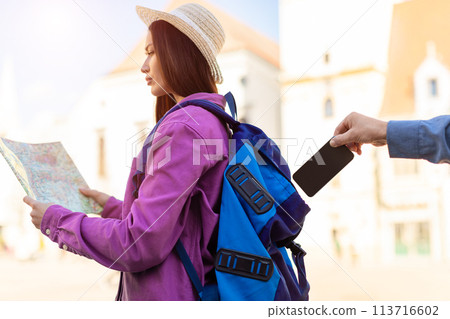 Tourist woman with map getting phone stolen Tourist woman with map getting phone stolen 113716602