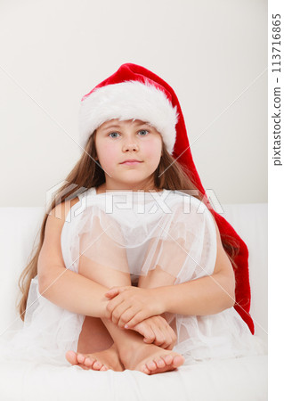 Little girl kid in santa claus hat. Christmas. 113716865
