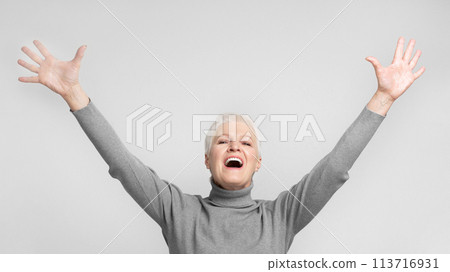 Elderly woman with arms raised and mouth open Elderly woman with arms raised and mouth open 113716931