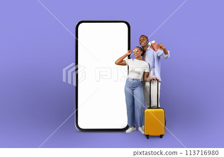 Couple looks at phone mockup, purple background 113716980