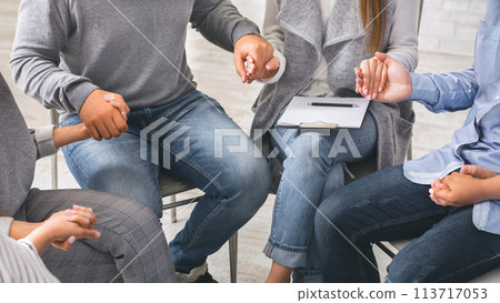 Group of addicted people holding hands, sitting in circle of trust Group of addicted people holding hands, sitting in circle of trust 113717053