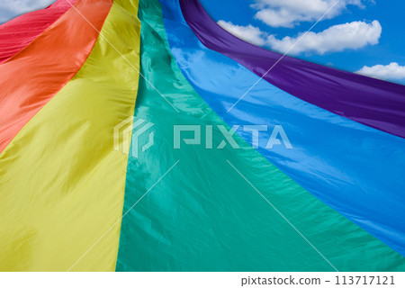 Fabric rainbow flag fluttering and going to sky. LGBT pride concept. pride month celebrates the festival background. Fabric rainbow flag fluttering and going to sky. LGBT pride concept. pride month celebrates the festival background. 113717121