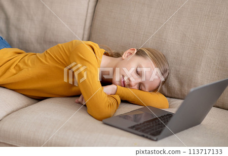Tired Teen Girl Felt Asleep On Couch After Using Laptop At Home Tired Teen Girl Felt Asleep On Couch After Using Laptop At Home 113717133