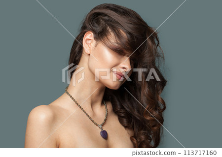 Green jasper necklace with heart pendant on jewelry model closeup on blue background 113717160