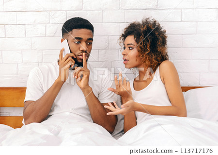 Couple arguing with man on phone call Couple arguing with man on phone call 113717176