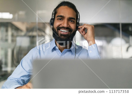 Businessman adjusting headset 113717358
