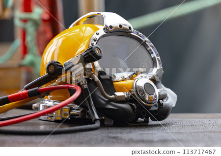 Yellow Commercial diving helmet on the ground closeup Yellow Commercial diving helmet on the ground closeup 113717467