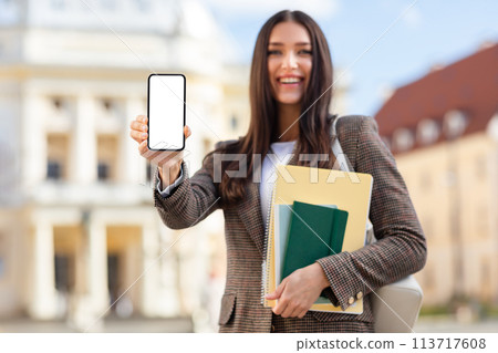 Student presenting smartphone screen to camera, mockup Student presenting smartphone screen to camera, mockup 113717608