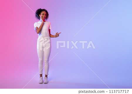 Woman gesturing on colored neon background 113717717