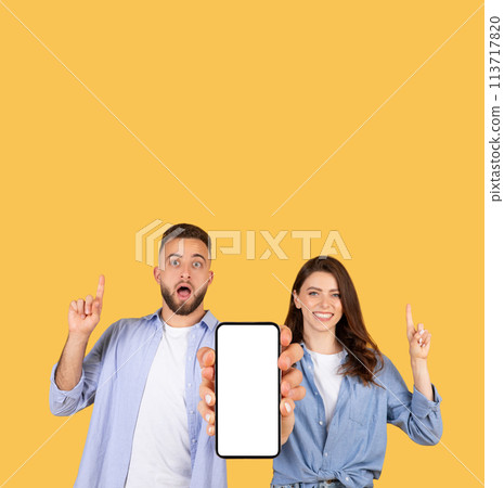 Couple pointing at blank phone screen Couple pointing at blank phone screen 113717820