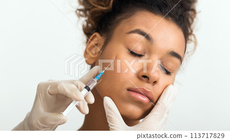 Beauty procedure. Woman receiving hyaluronic acid injection Beauty procedure. Woman receiving hyaluronic acid injection 113717829