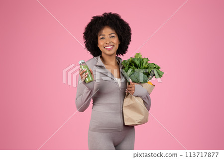 Cheerful woman with fresh groceries on pink background 113717877
