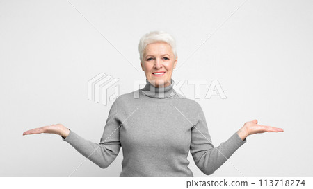 Joyful elderly woman with hands opened wide 113718274