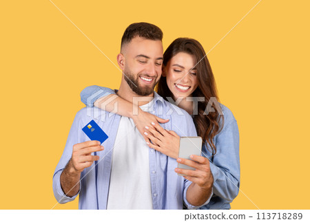 Couple with credit card and phone shopping online Couple with credit card and phone shopping online 113718289