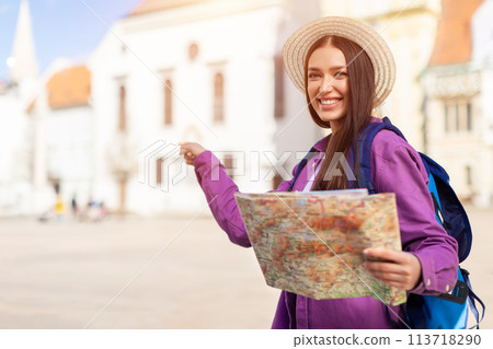 Happy woman with map inviting to explore city Happy woman with map inviting to explore city 113718290