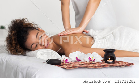 Woman enjoying aroma massage in spa salon Woman enjoying aroma massage in spa salon 113718292